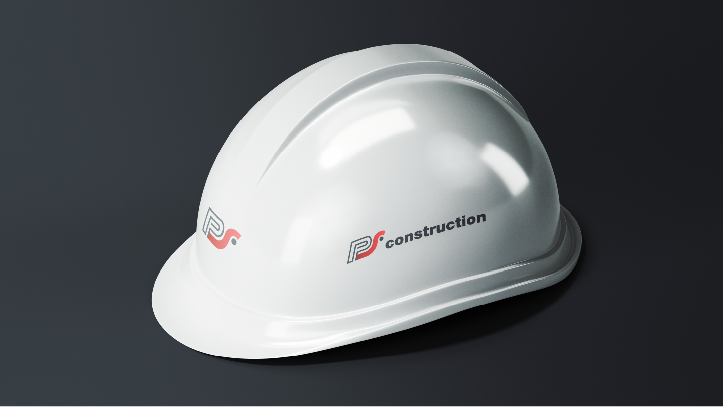 White construction hard hat with PS construction logo on dark background