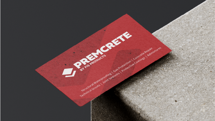 Red Premcrete business card placed on a concrete surface