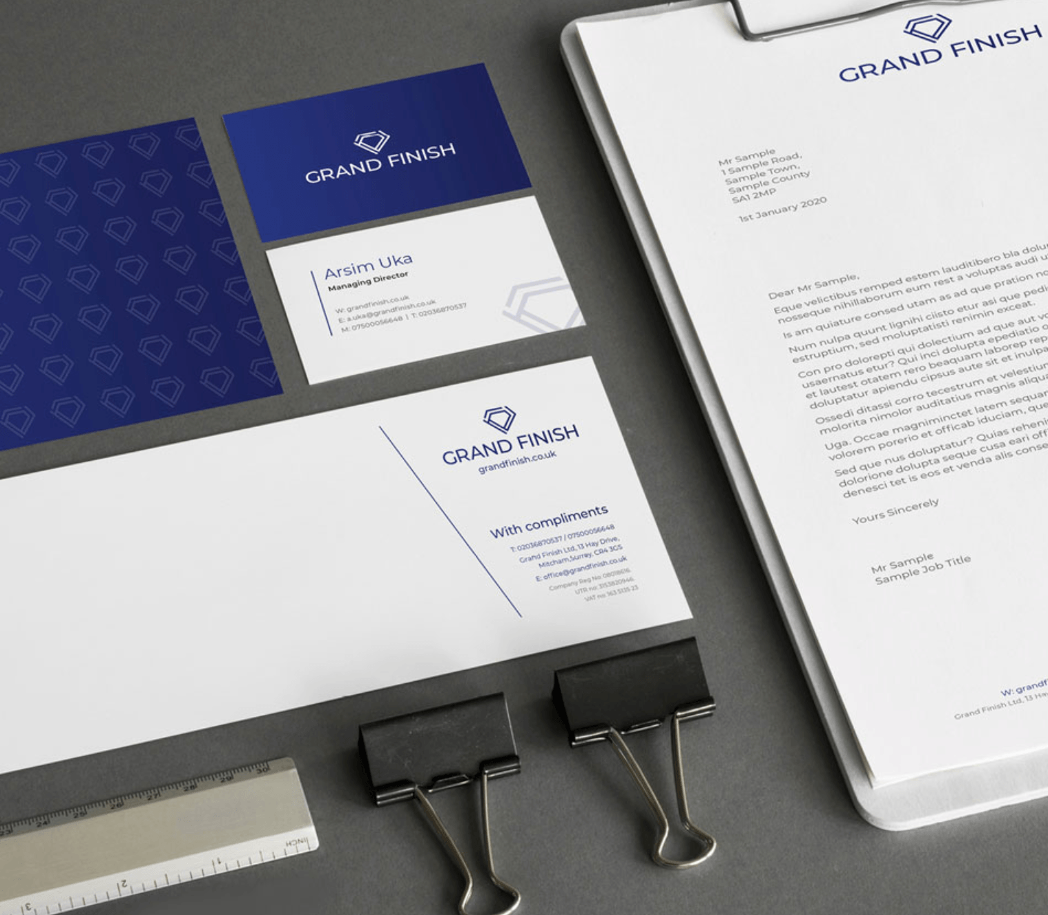 Grand Finish branded corporate stationery including business cards, letterhead, and compliment slips