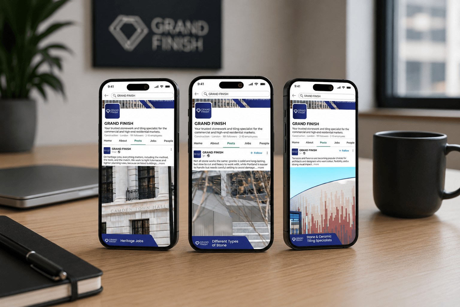 Three smartphones displaying Grand Finish social media posts on a wooden desk