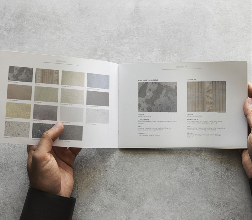 Hands holding open a brochure displaying limestone samples and descriptions
