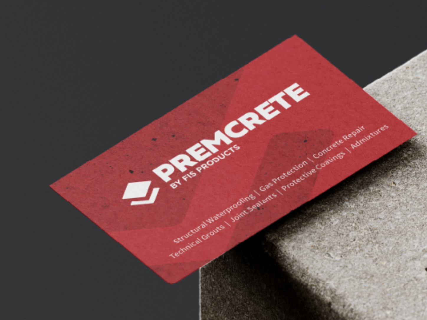 Red business card for Premcrete by FIS Products on a concrete block