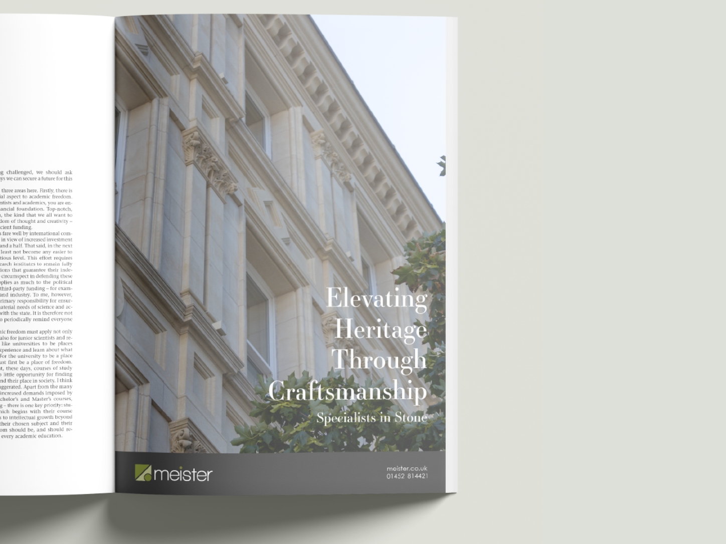 Open magazine showing an advertisement with a stone building facade and text about heritage craftsmanship