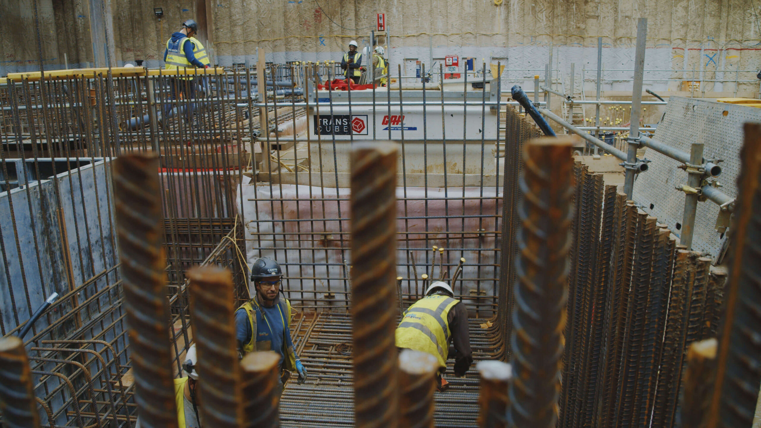 Construction workers installing steel reinforcement at building site