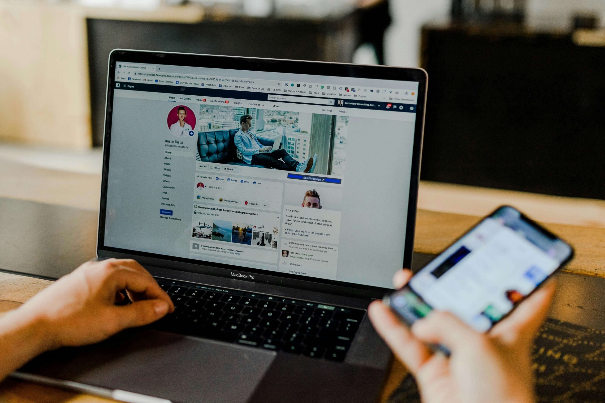 Person using Facebook on a laptop and smartphone for digital marketing