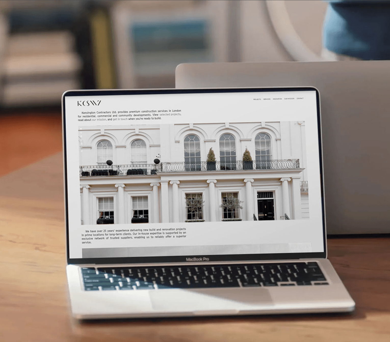 Laptop displaying Kensington Contractors website with building image