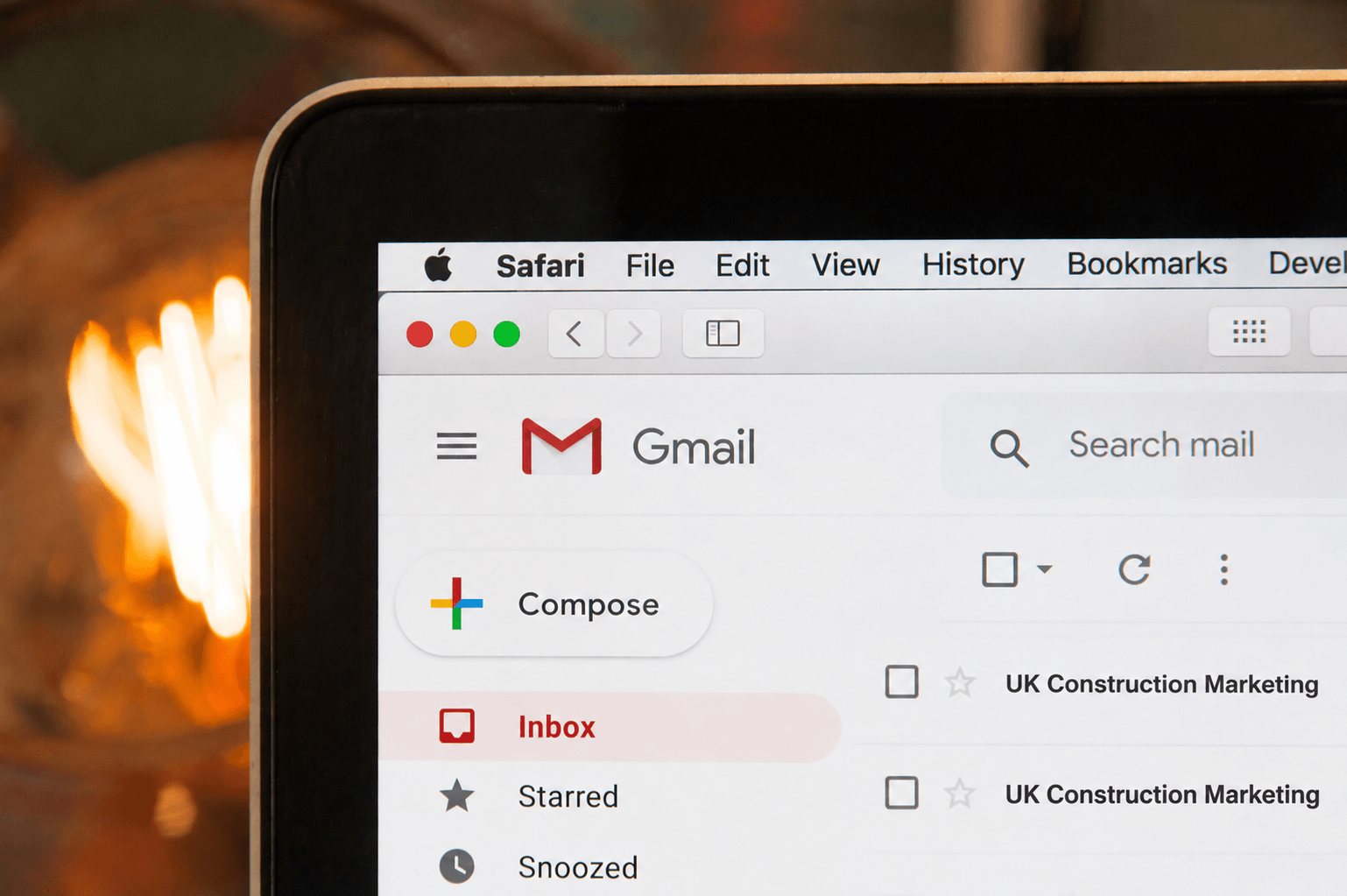 Close-up of a Gmail inbox on a laptop screen showing UK Construction Marketing emails