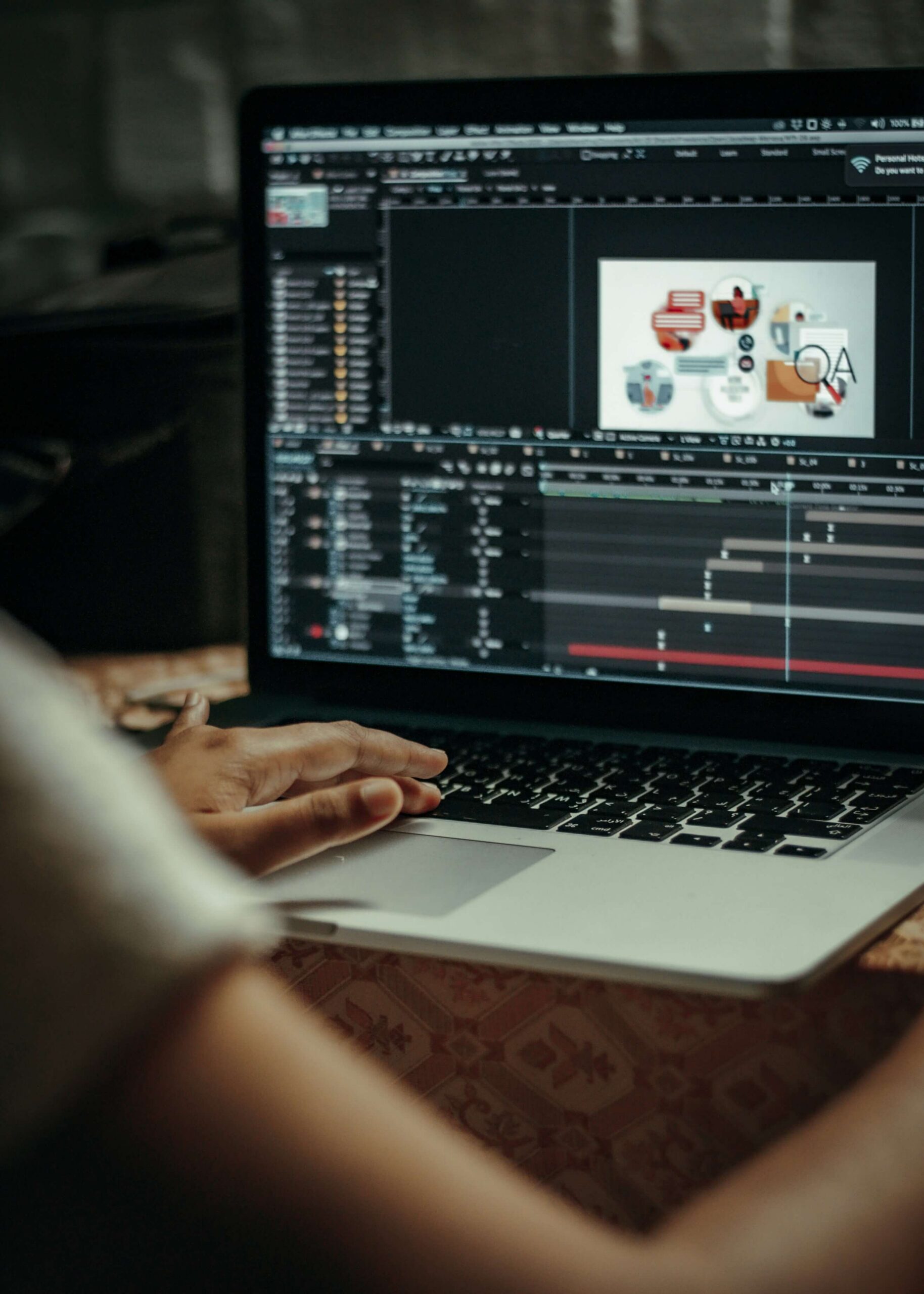 Person working on animation editing software on a laptop