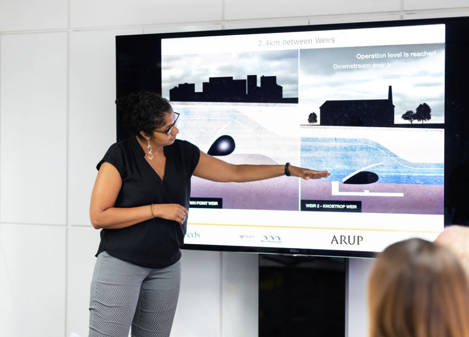 Woman presenting a water flow diagram from the UK Construction Marketing Arrup Report