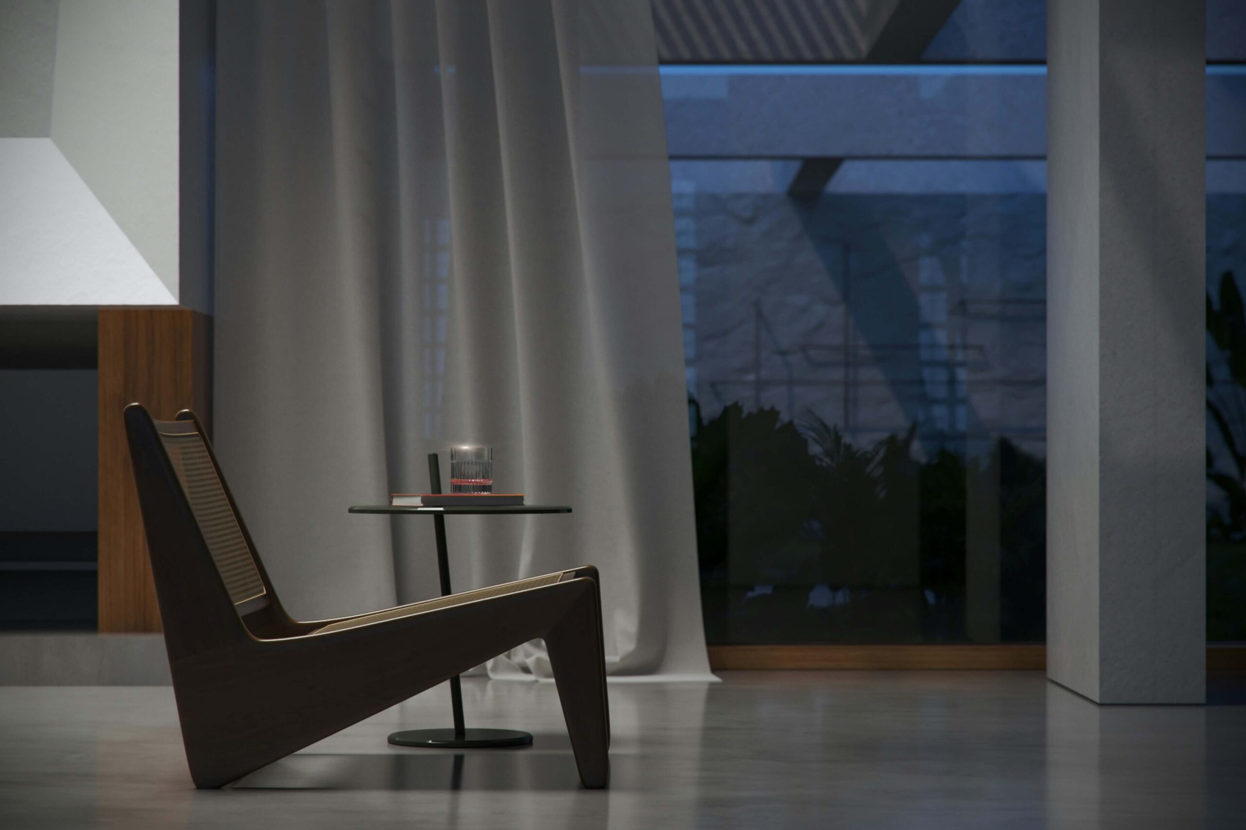 Modern lounge chair next to small round table with glass and book