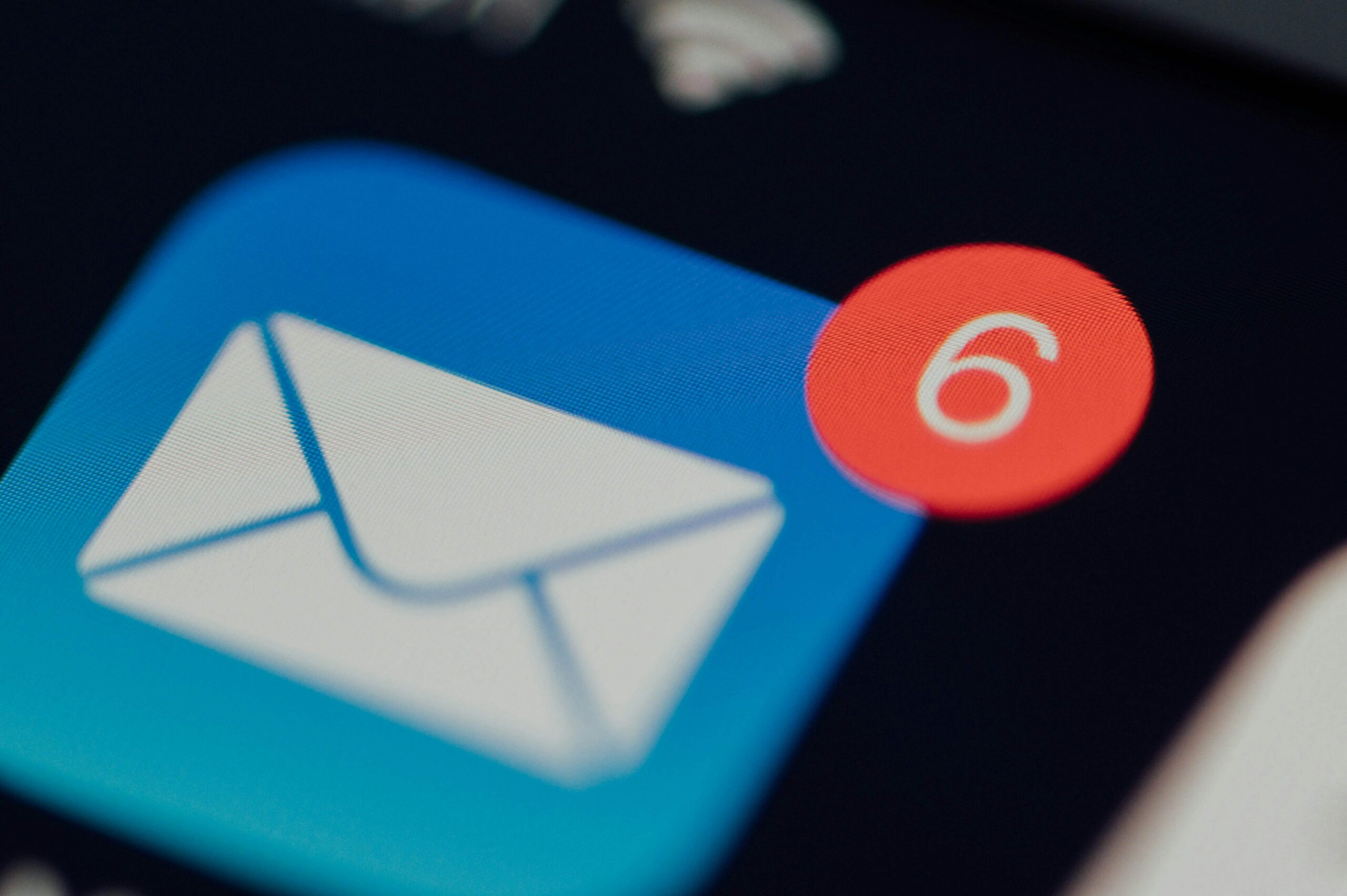 Email app icon with six unread messages notification on screen